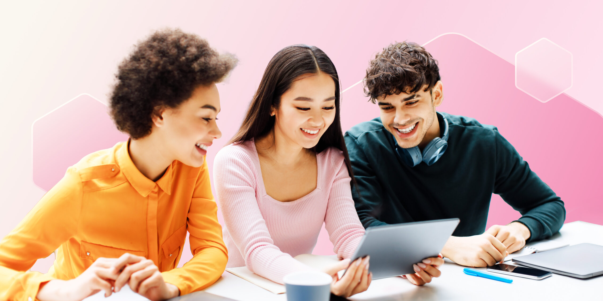 Image shows three students looking at a tablet