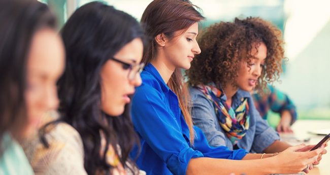 female students learning on cell phones